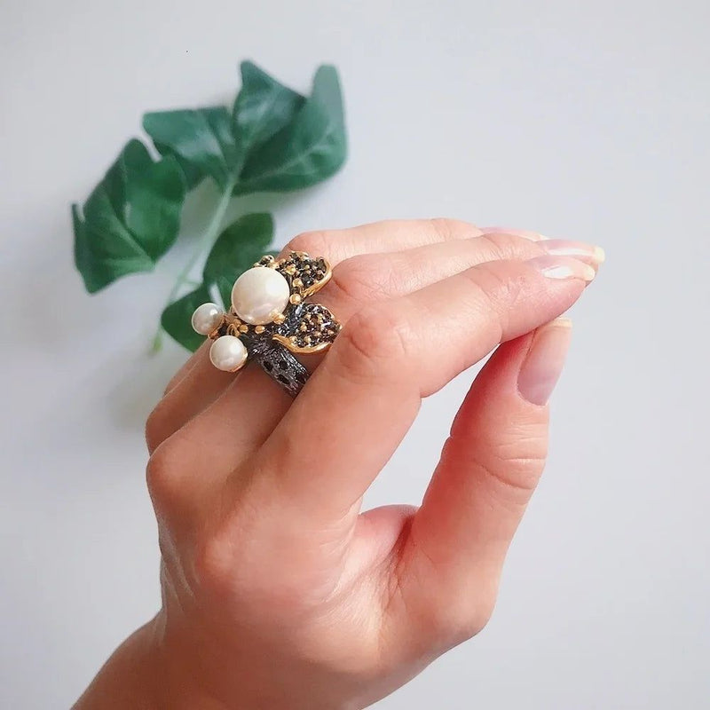 Elegant Blooming Floral Pearl Ring with Green Zirconia in Black Gold Design