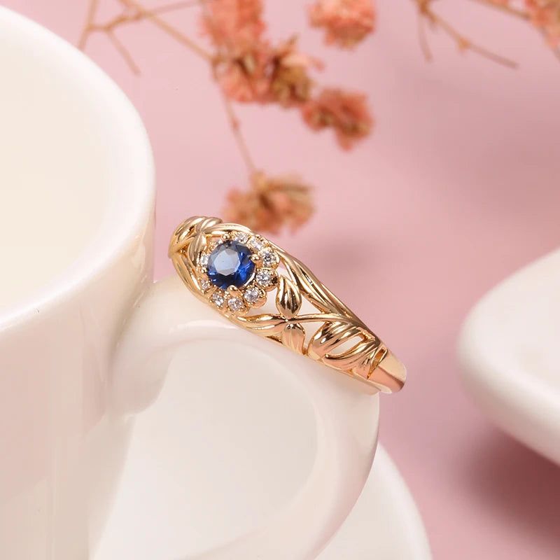 Vintage-Inspired Blue Zircon Rose Gold Cocktail Ring with Hollow Crystal Flower Design