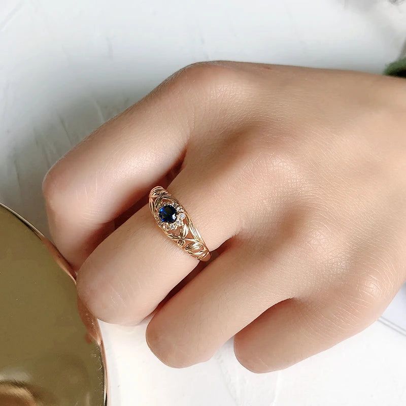 Vintage-Inspired Blue Zircon Rose Gold Cocktail Ring with Hollow Crystal Flower Design