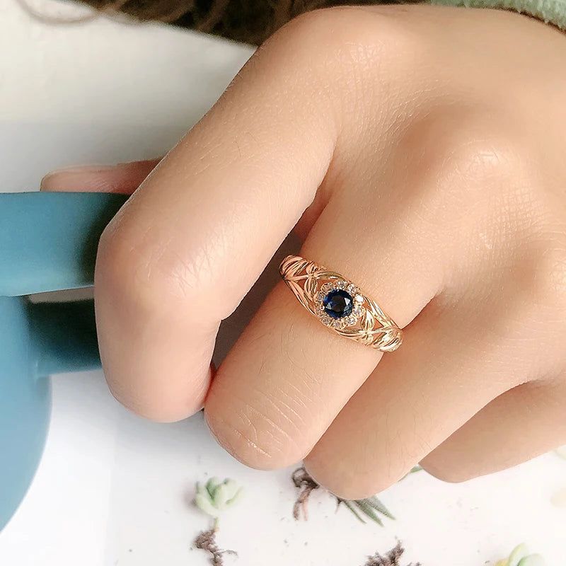 Vintage-Inspired Blue Zircon Rose Gold Cocktail Ring with Hollow Crystal Flower Design